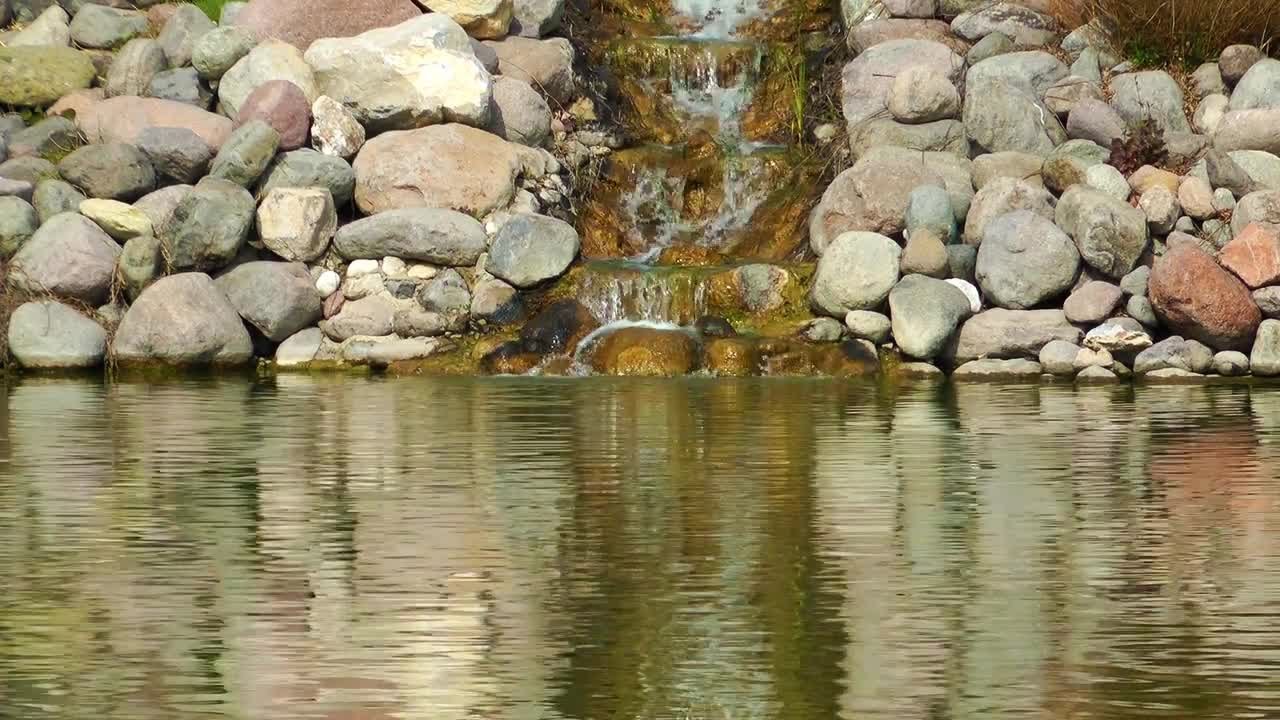 Waterfall Between Rocks On Lake Stock Video - YouTube