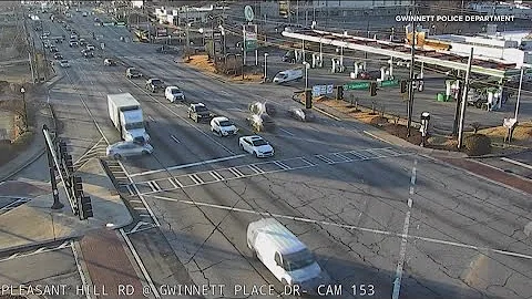 Truck hits car, pushes it through intersection in Gwinnett County hit-and-run