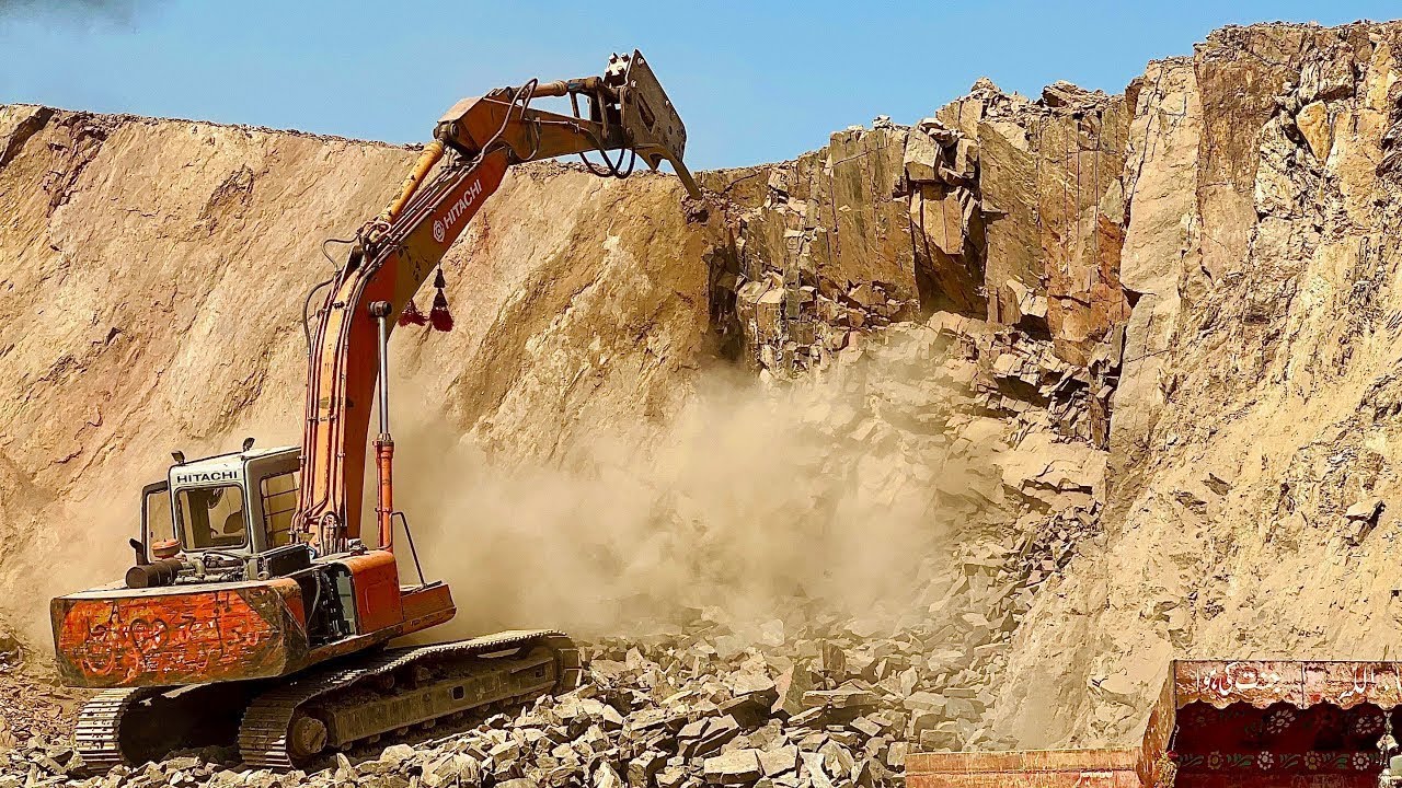 "Massive Rock Break with Excavator: Excavator's Power and Precision in Action"The excavator powerful