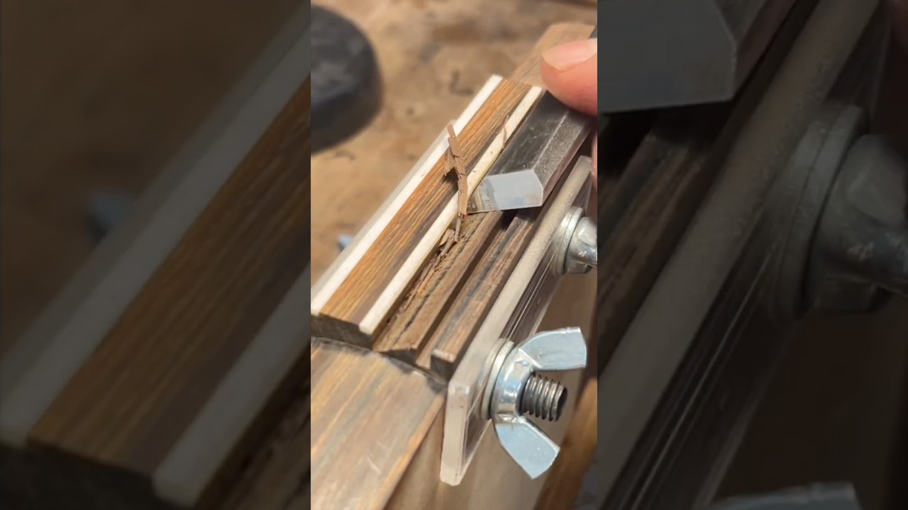 Pro luthier making a 7 string guitar bridge. 