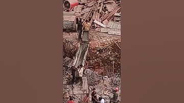 Pouring concrete with wheelbarrow #construction #workers #work #concrete #wheelbarrow #site #pouring