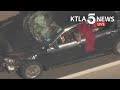 Driver in custody after leading pursuit with pit bull hanging out window in San Fernando Valley