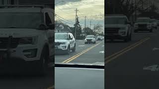 4 Nassau County police cars passing by