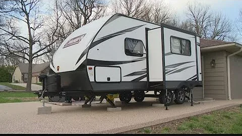 Doctor sleeps in camper to keep family members hea...