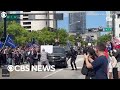 Protester detained after rushing trumps motorcade outside miami courthouse