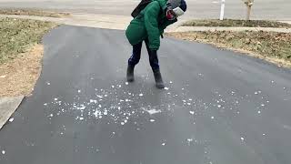 Spencer breaking ice in the driveway (slow motion)