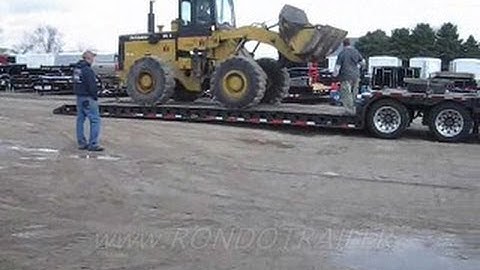 LOADING AN IH PAYLOADER ON A LOWBOY TRAILER PULLED BY PETERBUILT