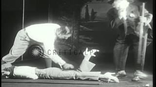 Australian golfer Joseph Henry Kirkwood demonstrates his skills on a stage in a 