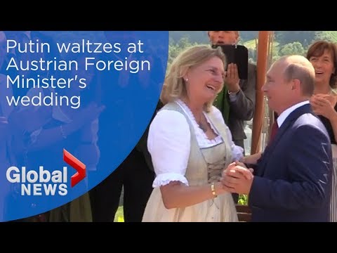 Putin waltzes arm-in-arm with Austria's Foreign Minister