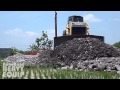 SHANTUI BullDozer Grading rocks in the Paddy field