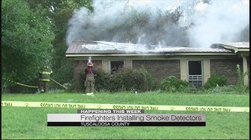 Firefighters installing smoke detectors
