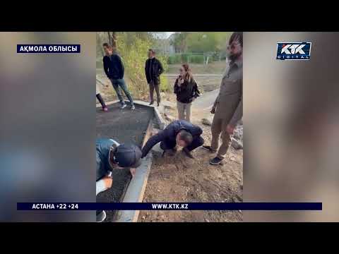 Residents of Stepnogorsk show officials poor-quality asphalt by tearing it up by hand