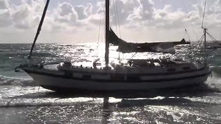 Group of migrants come ashore on Hollywood Beach after arriving on 30-foot sailboat