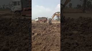 A yellow excavator digging land in the field #bachoeloader #excavator
