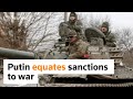 Putin likens sanctions to war, assault traps civilians