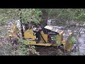 Struck - MAGNATRAC MH4900 small bulldozer, going through a swamp.