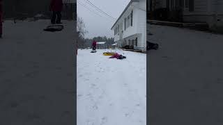 Girl attempts to jump onto snow tube but misses and faceplants into scorpion position