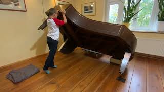 A concert grand piano can be tilted up and down from the trolley with just one person child's play!