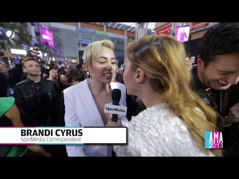 Miley Cyrus Talks To Sister Brandi In An Exclusive AMA Red Carpet Interview