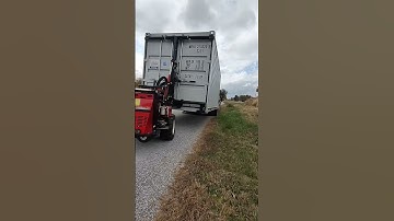 Commercial shipping container 8x20 unloaded at the street then rolled into place for onsite storage.