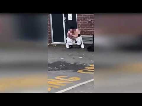 Shocking moment woman is caught squatting in Farmfoods car park relieving herself