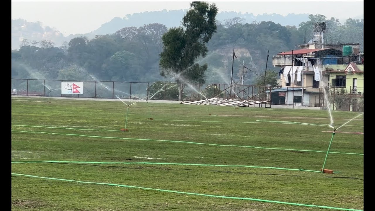 Watering all over the Mulpani cricket ground to make the ground green and smooth.