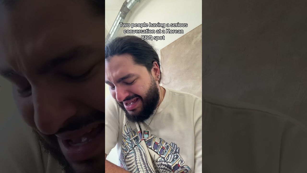 Two people having a serious conversation at a Korean BBQ spot