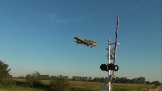 Crop-dusting plane & distant coal train