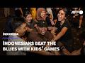Burnt-out Indonesians beat the blues with children's games | AFP
