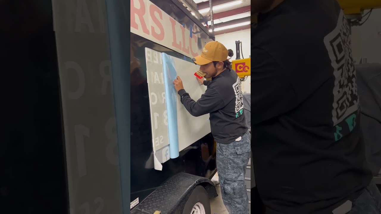 Vinyl lettering installation on trailer 
