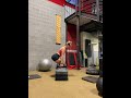 Elevated suitcase deadlifts using dumbbells