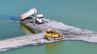 SHANTUI Truck Spreading Rock and Dozer Pushing Stone on a Fantastic Lake Road Construction Project