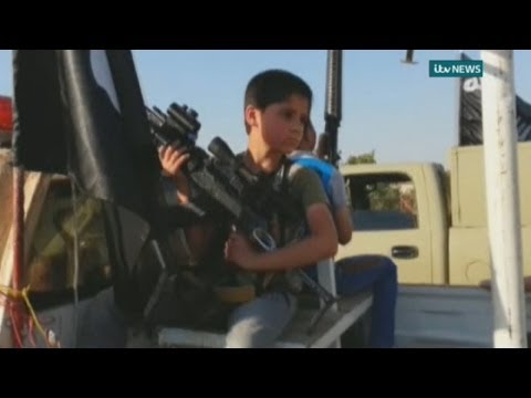 Children armed with rifles parade in ISIS convoy through Mosul