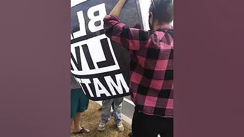 Man attacks woman and son flag holders intervene. ...