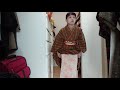 オレンジ色のチェックの単衣ウールの着物と黒地に明るい青緑や黄色が入った博多織の半幅帯