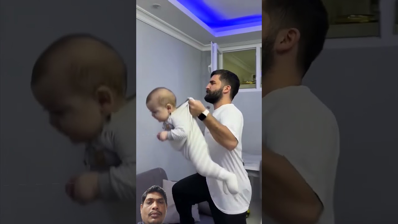 সন্তান ঘুমায় না দেখে তাকে ধরে এনে ঘড়ির টাইম দেখাইতেছে ঘুমানোর জন্য