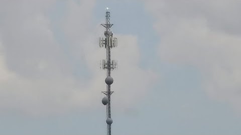 A guyed tower with an LED beacon that replaced a nonfunctional xenon strobe and 300mm beacon 