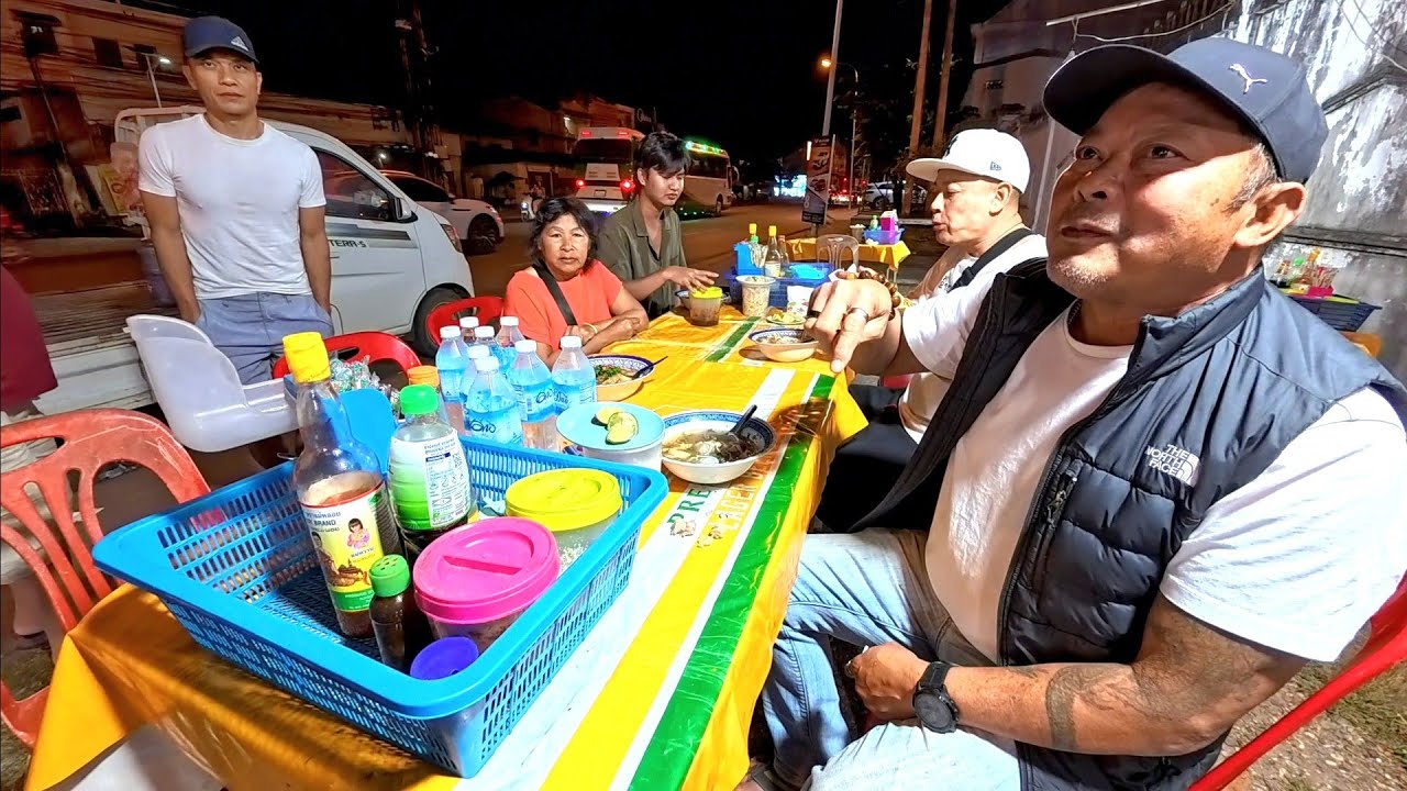 Outdoor restaurant by the street with Kon Lao from America and France 