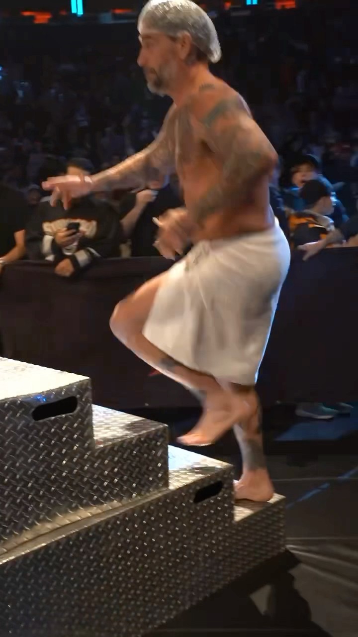 CM Punk leaves the shower to help out