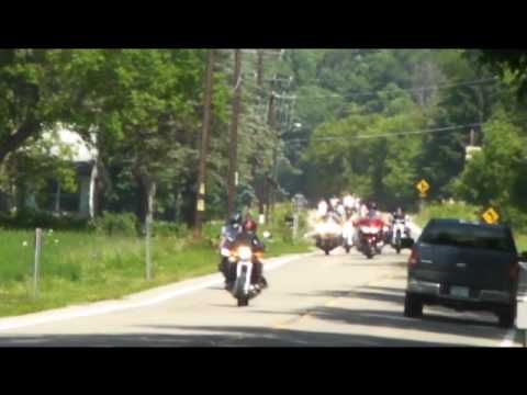 This is the second of two videos showing the parade style motorcycle charity ride known as Rock and Roar 2010 as it travels down RT 36 between Canisteo and the hamlet of South Canisteo in New York state. Please note that this video clip has TWO near miss crashes in it. One involves a motorcycle and car, the other was an SUV and pickup truck. Rock and Roar is a yearly event that raises tons of money every year for worthy charities. The event is produced by the Arkport Harley Owners Group but is attended by anywhere from 500-800 motorcycles of all makes every year. Rock And Roar 2010 is dedicated to the memory of Kenneth "Skip" Cole. Skip was one of the original HOG members that started this event. He passed away just this year. You can find out more about Rock and Roar by going to their website at www.rockandroar.com My apologies to viewers for the occasionally shaky video. I did not anticipate the need for a tripod for the camera and my diabetes gave me a wicked case of the shakes. Please be sure to visit and subscribe to both of my channels. The first is http The second is: www.youtube.com And please click on "Save To" and then chose favorites for each video that you like. A "Thumbs Up" is also pretty gnarly too. Rock and Roar and VidCon HAVE to be the two best events of the year!!