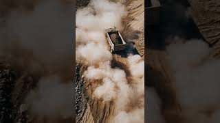 Aerial Documentary Shot of a Rugged Soil Loaded Dump Truck Racing Across Rough Terrain, #Shorts