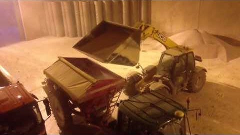 JCB loading Bredal K65 Fertiliser Spreader