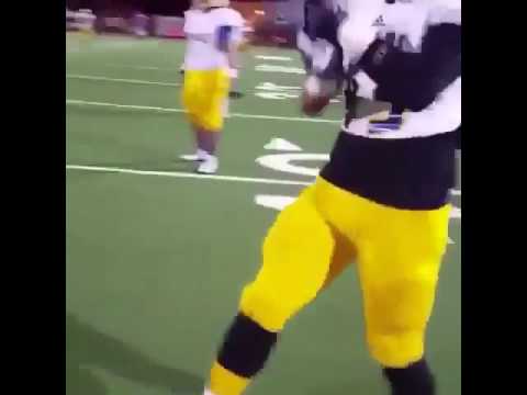 Football Players Making Cool Beat With Football Pads