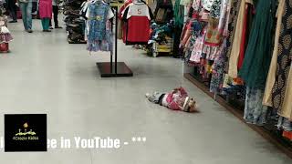 Cute Little Kid Gets Bored Enjoys Playing On Floor While Parents Are Busy Shopping In A Mall.