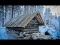 Solo building a small log cabin on the cliff of the river