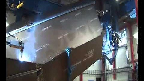 Motoman robot welding a dumper truck bed