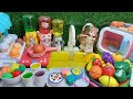 Cook mini food dishes in the kitchen set by cutting fruit and vegetables with hello kitty play set