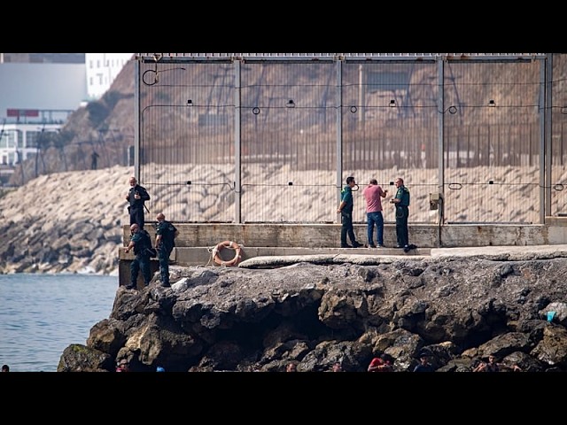 Spain mobilises troops as thousands swim across border from Morocco