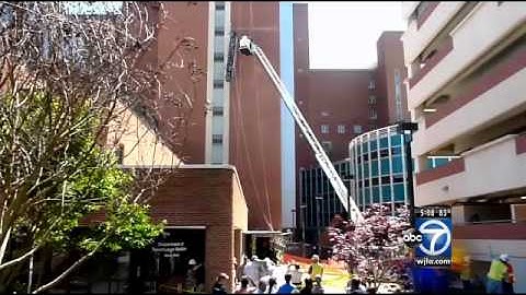 Firefighters rescue window-washers after scaffolding collapses
