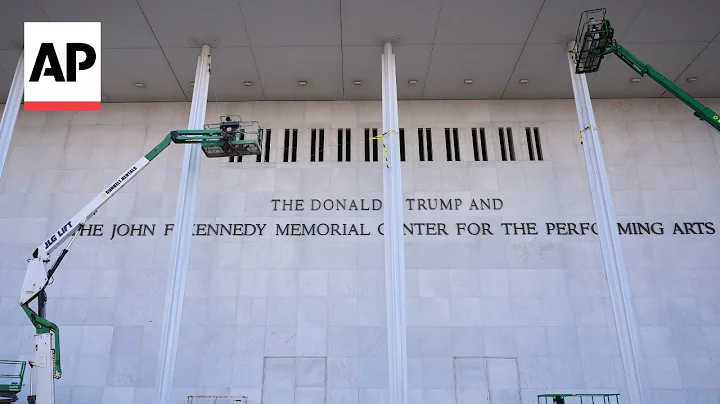 Workers add Donald Trump's name to the Kennedy Center building